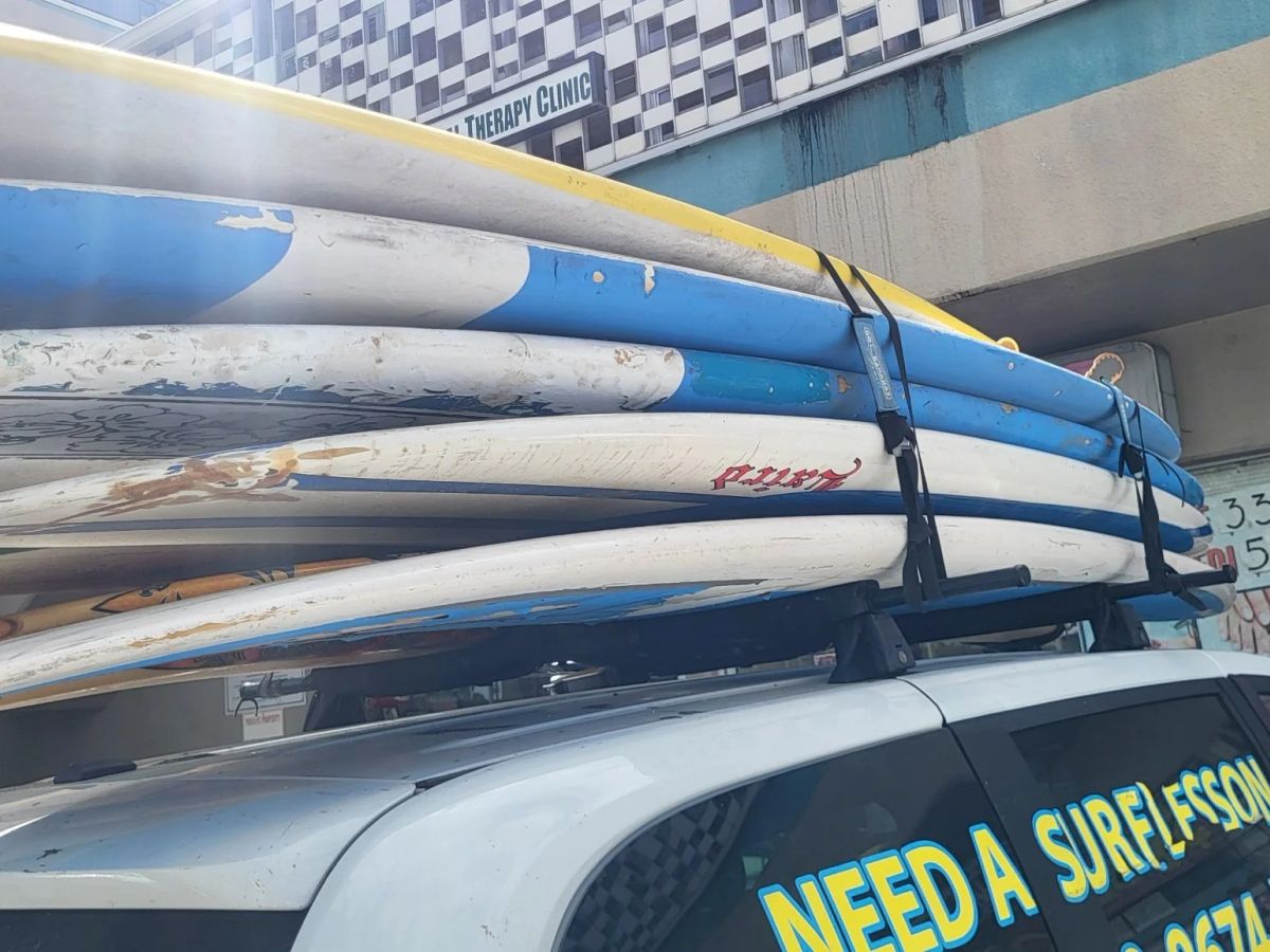 SFC lesson boards secured on a vehicle before a surf day