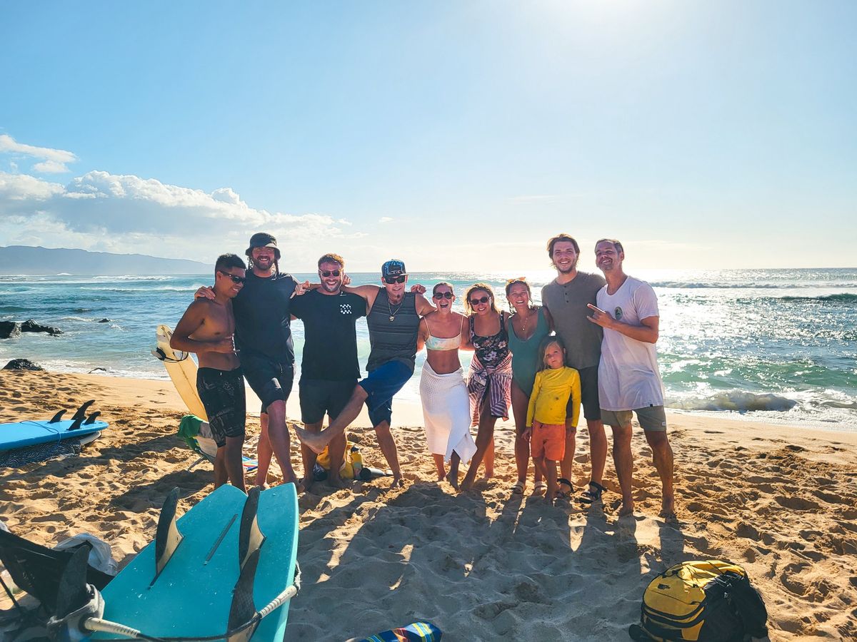 A family surf lesson group on the Waikīkī beach