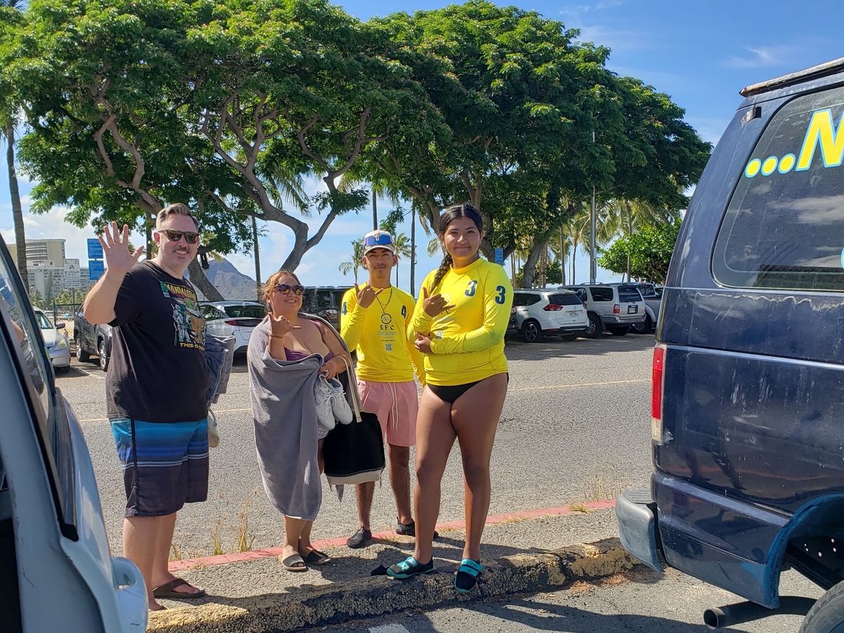 A family arriving at the SFC surf shuttle near Waikiki parking