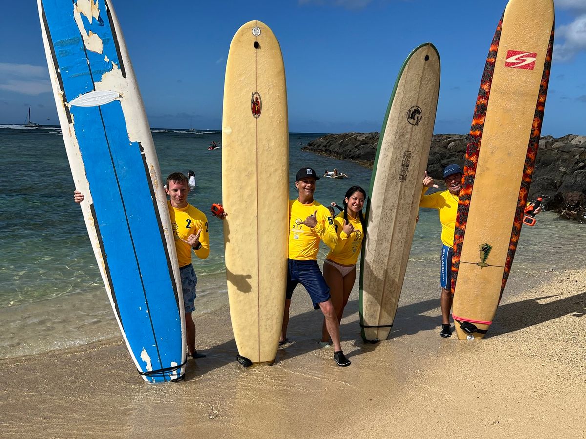 Lesson boards lined up on the Waikīkī sand for SFC guests